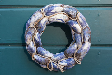 Seashell wreath on wooden wall