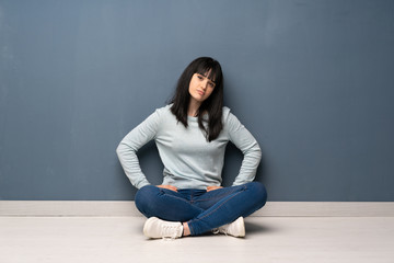 Woman sitting on the floor angry