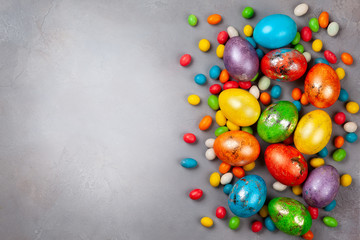 Colorful Easter eggs and chocolate Easter sweets.