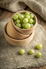 Fresh gooseberry in a wooden bowl.