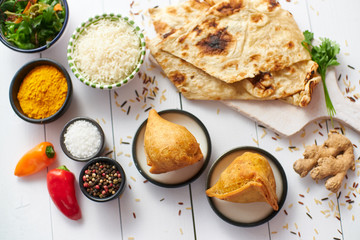 Traditional Indian Food snack Samosa served in a plate on a white wooden table