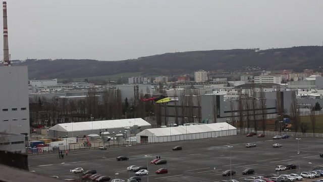 Helicopter take off and transfers cargo, Mlada Boleslav, Czech Republic.