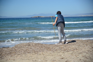 Two boys recycling plastic bottles and leftovers near the beach