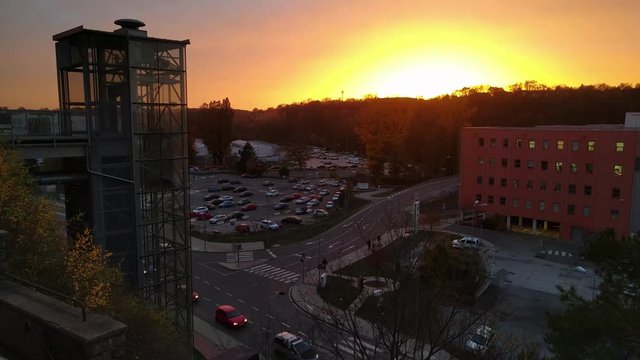Timelapse of modern glass elevator in front of technical center Cesana on the background of sunset, Mlada Boleslav, Czech Republic