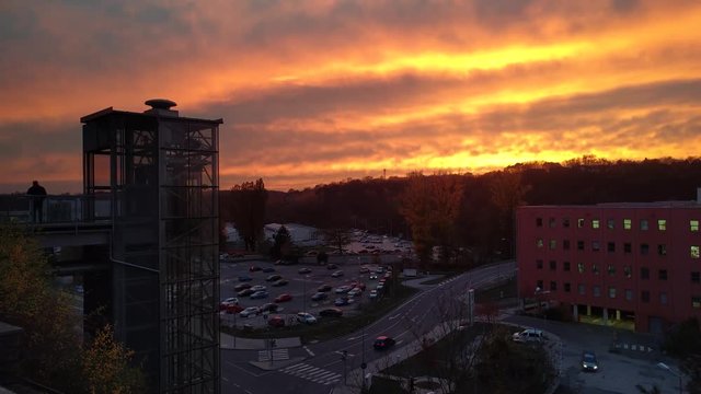 Timelapse of modern glass elevator in front of technical center Cesana on the background of sunset, Mlada Boleslav, Czech Republic