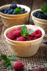 Blackberries, raspberries and blueberries in a waffle bowls.