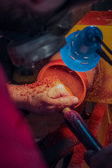 Joiner processes wood on a lathe
