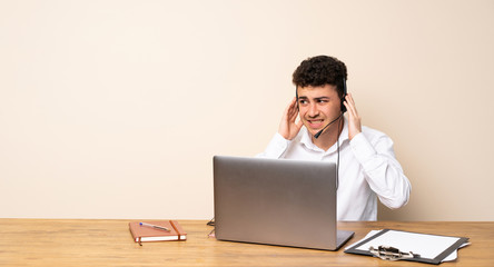 Telemarketer man frustrated and covering ears