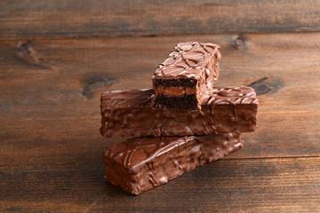closeup sliced chocolate cream filled bar cake on wood