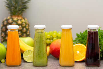 Assortment of fruit and vegetables smoothies in glass bottles. Fresh organic Smoothie ingredients. Detox, dieting or healthy food concept. Vegetarian food.