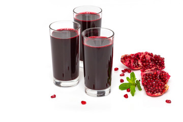 Pomegranate juice with pomegranate on a white background. Ripe pomegranate fruit juice glass.