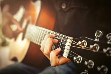 woman playing acoustic guitar