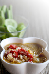 Herb Soya Beans with Minced Shrimp and Pork in Coconut Milk and chili in white bowl served with Fresh Vegetables, special recipe well decorate Thai tradition food sold in restaurant and market