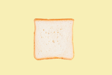 Single slice of toast bread isolated on yellow background
