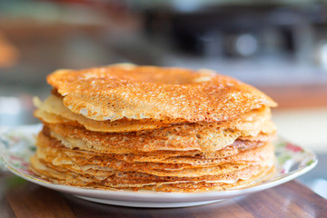 A stack of crispy rosy pancakes on a plate