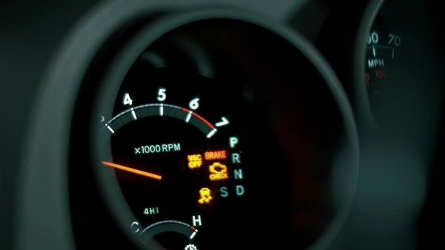 The arrow of the speedometer and tachometer is increased to a high value of the engine speed, quickly driving in the car