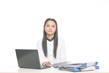 Office lady in white shirt and ponytail hair using a laptop and file