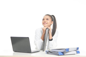 Office lady in white shirt and ponytail hair using a laptop and file