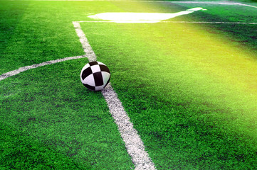 Soccer ball on the green grass field