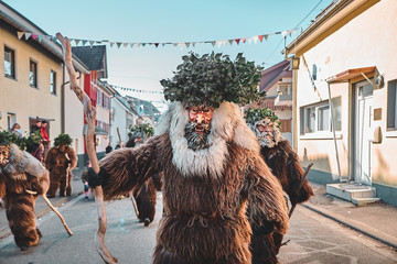 Haired wild man posing in front of the camera. Carnival party in southern Germany - Black Forest.