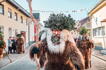 Haired wild man is looking into the camera. Carnival party in southern Germany - Black Forest.