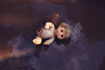 broken doll in the trash.the concept against abortion.