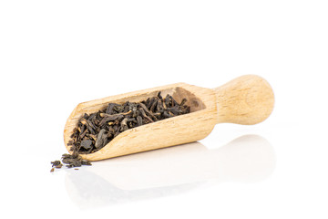 Lot of pieces of dry black tea earl grey with wooden scoop isolated on white background
