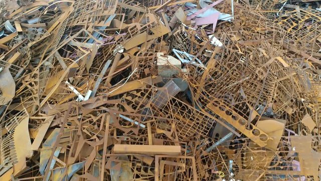 Low altitude aerial view of scrap metal recyclable materials left over from product manufacturing and consumption the more frequently recycled metals are steel iron lead aluminium copper and zinc 4k