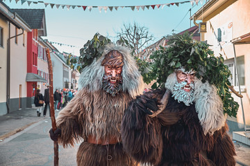 Two brown haired wild men. Carnival party in southern Germany - Black Forest.