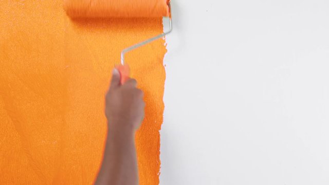 Painting of walls in a oranges color for repair old paint in a house
