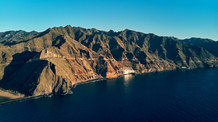 view from the sea to Punta de los Organos and the surrounding mountains air photo