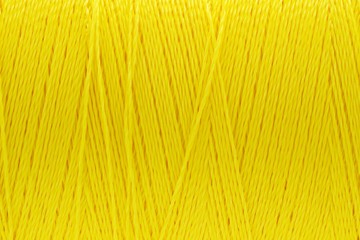 Macro picture of thread texture yellow color background