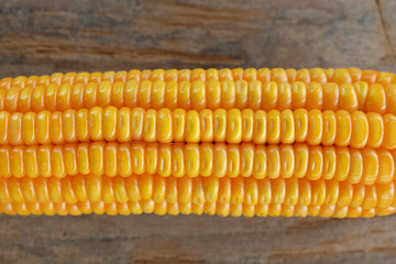 Grains of ripe corn on wooden background. Corn cob on wooden background