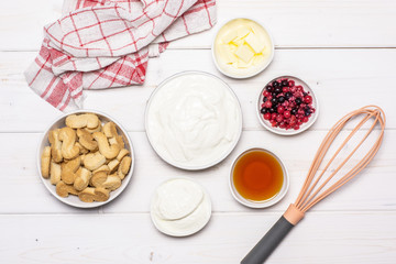 Ingredients. recipe step by step no bake cheesecake flatlay on white wood