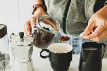 Obraz na płótnie Canvas Asian man make a cup of coffee on table at home