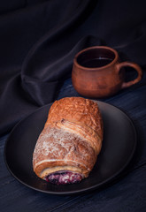 Coffee and cake with filling on dark background