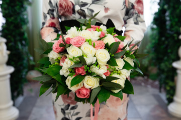 Beautiful bouquet of flowers for wedding ceremony in the hands of the bride