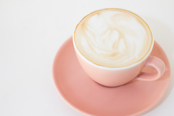Hot coffee of cup trendy color of the year 2019 living coral. On wooden background