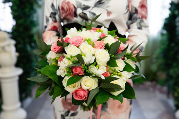 Beautiful bouquet of flowers for wedding ceremony in the hands of the bride