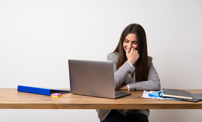 Business woman in a office smiling a lot