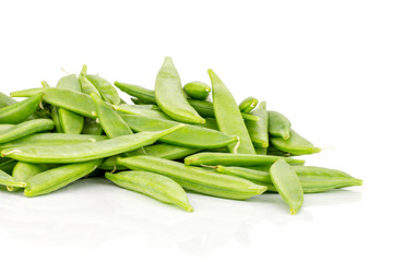 Lot of whole green sugar snap pea pods stack isolated on white background