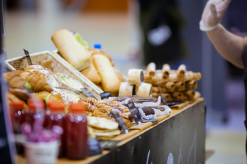 Sweets and pies on the counter in the store with bread