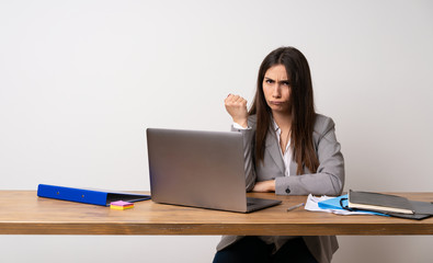 Business woman in a office with angry gesture