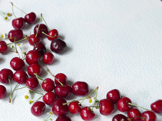 Ripe delicious cherries on the white tablecloch whit the copy space