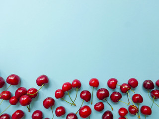 Ripe delicious cherries on the blue background whit the copy space