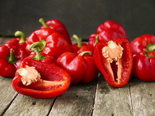Fresh sweet red pepper on old wooden background