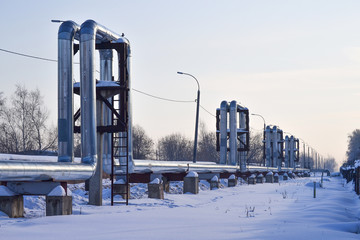 Overground heat pipes. Pipeline above ground, conducting heat for heating the city. Winter. Snow.