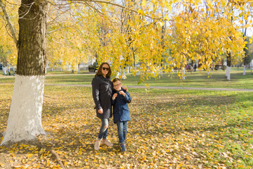 Fototapeta premium boy with mother walk in the autumn park