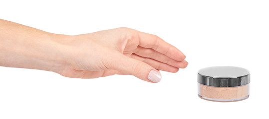 Hand with beige face powder, skin care and beauty.