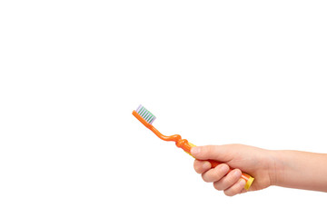 Kids hand with orange toothbrush, dental care concept
